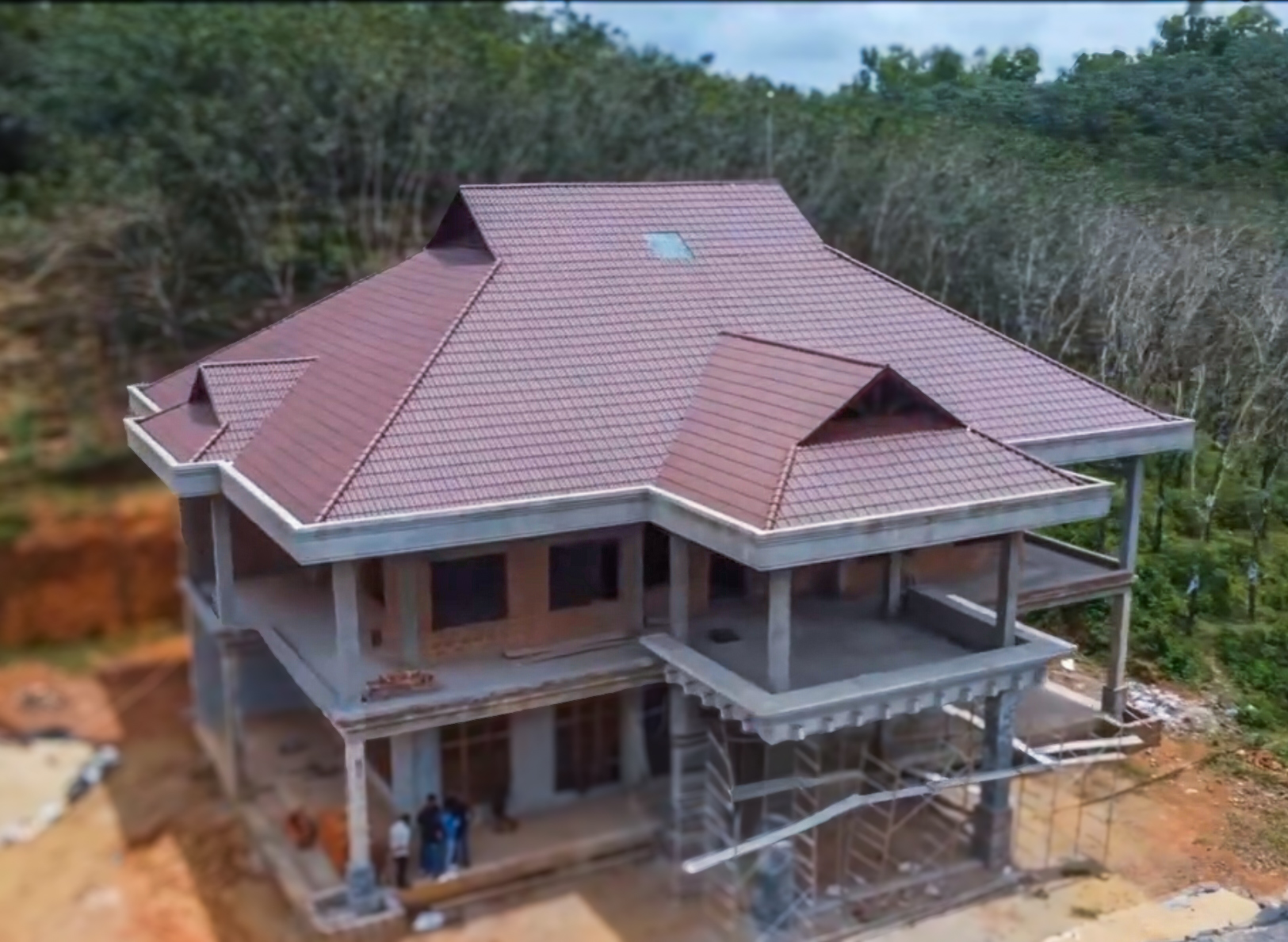 Large home with red roofing under construction